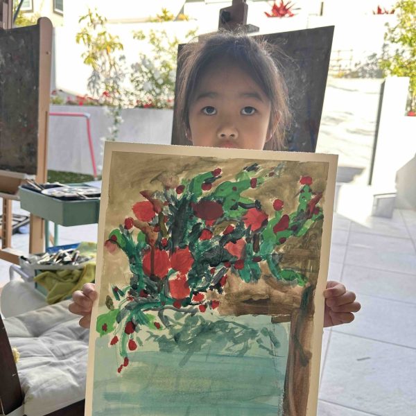 Home 19 Young student holding a floral painting during a kids art class at VIMA Gallery in San Diego
